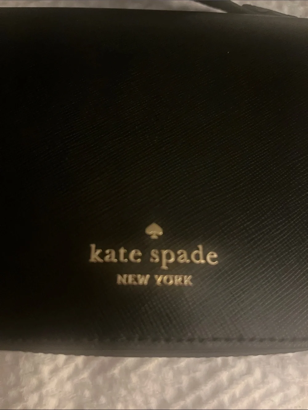 Kate Spade black crossbody saddlebag with gold logo